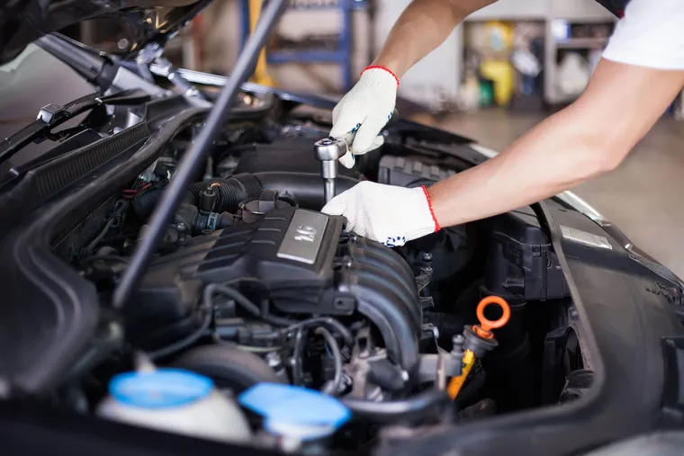 Mechanic performing European auto repair at Central Motor Sales